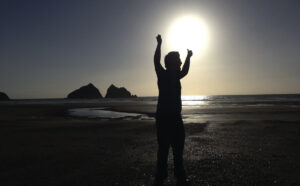 Silhouetted figure holding fists in the air