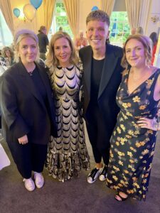 Green Light team members Leanne Thomas, Bartek Winiecki, and Jude Woods with Sally Phillips celebrating at the Proud to Care Awards 2026